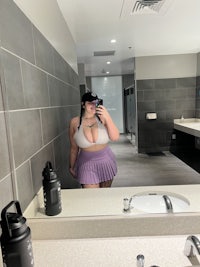 a woman taking a selfie in a bathroom