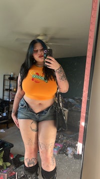 a woman taking a selfie in a mirror